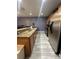 Modern kitchen featuring stainless steel appliances, granite countertops, and wood cabinets at 8973 Cat Palm Rd, Kissimmee, FL 34747