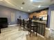Open concept kitchen featuring an eat-in counter with modern appliances and gray vinyl flooring at 8973 Cat Palm Rd, Kissimmee, FL 34747