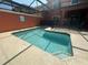 Sparkling in-ground pool enclosed in a screened lanai with comfortable lounging space at 8973 Cat Palm Rd, Kissimmee, FL 34747
