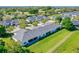 An aerial perspective of townhomes with lush greenery, and landscaping in a serene setting at 1017 Green Gate Blvd, Groveland, FL 34736