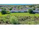 Aerial view of complex surrounded by lush vegetation and lakes at 1017 Green Gate Blvd, Groveland, FL 34736
