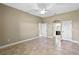 Bedroom with an arched entrance to bathroom and tiled floor and neutral paint at 1017 Green Gate Blvd, Groveland, FL 34736