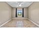 Empty bedroom with a tile floor, neutral walls and a large window at 1017 Green Gate Blvd, Groveland, FL 34736