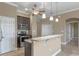 Open kitchen featuring stainless steel appliances and a granite breakfast bar at 1017 Green Gate Blvd, Groveland, FL 34736