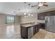 Modern kitchen with stainless steel appliances and granite countertops overlooks the living area at 1017 Green Gate Blvd, Groveland, FL 34736