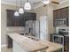Kitchen with dark cabinetry, stainless steel appliances, and granite countertops at 1017 Green Gate Blvd, Groveland, FL 34736