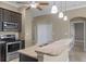 Open kitchen with granite countertops and stainless steel appliances at 1017 Green Gate Blvd, Groveland, FL 34736