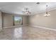 Spacious living room featuring tile flooring, ceiling fan, and a large window at 1017 Green Gate Blvd, Groveland, FL 34736