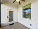 This porch with ceiling fan and tile floor offers a lovely view from the window and door at 1017 Green Gate Blvd, Groveland, FL 34736