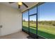 The screened in porch has a ceiling fan, tile flooring, and views of the backyard at 1017 Green Gate Blvd, Groveland, FL 34736