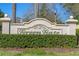Welcoming entrance sign for The Villas at Green Gate, surrounded by manicured hedges at 1017 Green Gate Blvd, Groveland, FL 34736