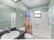Updated bathroom featuring a shower/tub combo and stylish black granite vanity at 1033 Scotch Pine Ct, Leesburg, FL 34788