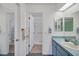 Clean bathroom featuring a single vanity and a walk-in shower at 1033 Scotch Pine Ct, Leesburg, FL 34788