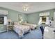 Inviting bedroom featuring two twin beds and comfortable blue carpet at 1033 Scotch Pine Ct, Leesburg, FL 34788