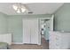 Cozy bedroom features mint walls, tile floors, and a closet for ample storage at 1033 Scotch Pine Ct, Leesburg, FL 34788