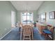 Classic dining room featuring a wooden table set for four, complemented by ample natural light and simple decor at 1033 Scotch Pine Ct, Leesburg, FL 34788