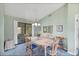 Charming dining room featuring a wood table with blue accents and natural light from sliding glass door at 1033 Scotch Pine Ct, Leesburg, FL 34788