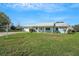 Attractive single-story home with a well-maintained lawn and an attached garage, enhancing curb appeal at 1033 Scotch Pine Ct, Leesburg, FL 34788