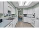 Bright kitchen features white cabinetry, tile flooring, and a view into the adjacent dining area at 1033 Scotch Pine Ct, Leesburg, FL 34788