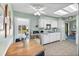 Bright kitchen with white cabinets, skylight, and dining area at 1033 Scotch Pine Ct, Leesburg, FL 34788