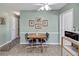 Casual breakfast nook with tile flooring, ceiling fan, and adjacent microwave area at 1033 Scotch Pine Ct, Leesburg, FL 34788