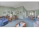 Expansive living room with a comfortable seating area, traditional decor, and easy access to the dining space at 1033 Scotch Pine Ct, Leesburg, FL 34788