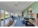 Bright sunroom offers plenty of natural light and comfortable seating at 1033 Scotch Pine Ct, Leesburg, FL 34788