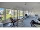 Sunroom with large windows and neutral walls provides plenty of natural light at 1033 Scotch Pine Ct, Leesburg, FL 34788