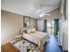 Bright bedroom with vaulted ceilings, stylish decor, and sliding glass doors leading to a private balcony for relaxed outdoor living at 1051 S Highland St # 7E, Mount Dora, FL 32757