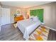 Charming bedroom with modern decor, featuring wood floors and ample natural light at 1051 S Highland St # 7E, Mount Dora, FL 32757
