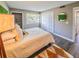 Cozy bedroom with wood floors, a window, and built in closet at 1051 S Highland St # 7E, Mount Dora, FL 32757