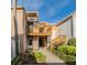 Charming condo with a private balcony and lush landscaping, creating a welcoming entrance at 1051 S Highland St # 7E, Mount Dora, FL 32757