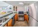 Efficient kitchen with stainless steel appliances and wooden cabinets at 1051 S Highland St # 7E, Mount Dora, FL 32757