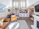 Open-concept living space with high ceilings, modern bar stools, and fireplace at 1051 S Highland St # 7E, Mount Dora, FL 32757