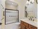 Arched alcove houses a shower and bath combo along with a vanity and matching mirror at 10929 Se 167Th Pl, Summerfield, FL 34491