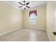 Empty room features tile floor, a ceiling fan, one window, and neutral colored walls at 10929 Se 167Th Pl, Summerfield, FL 34491
