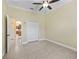 Bright bedroom with closet space and a view into the kitchen at 10929 Se 167Th Pl, Summerfield, FL 34491