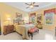 Tastefully decorated bedroom featuring beautiful furniture, tile floors, and decorative curtains and wall art at 10929 Se 167Th Pl, Summerfield, FL 34491