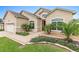 Inviting home exterior with lush landscaping, manicured lawn, and a welcoming front entrance at 10929 Se 167Th Pl, Summerfield, FL 34491