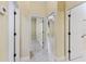 Hallway with tile floors and many doorways leading to other rooms in the house at 10929 Se 167Th Pl, Summerfield, FL 34491