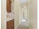 Hallway with tile floors, arched doorway, and a built-in counter and mosaic backsplash at 10929 Se 167Th Pl, Summerfield, FL 34491