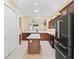 Modern kitchen featuring stainless steel appliances, dark cabinets, and a center island at 10929 Se 167Th Pl, Summerfield, FL 34491