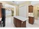 An eat-in kitchen features a center island, stainless steel appliances, and ceramic tile flooring at 10929 Se 167Th Pl, Summerfield, FL 34491