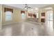 The open concept living room has tile floors, base molding, and plantation shutters on the windows at 10929 Se 167Th Pl, Summerfield, FL 34491
