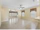 A formal living room with ceramic tile floors, base molding, and plantation shutters on the windows at 10929 Se 167Th Pl, Summerfield, FL 34491