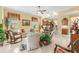 A stylish living room is decorated with paintings, furniture, and plants to give it an elegant style at 10929 Se 167Th Pl, Summerfield, FL 34491