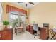 Well-appointed office featuring a large window, stylish desk, and comfortable seating at 10929 Se 167Th Pl, Summerfield, FL 34491