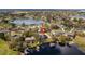 Breathtaking aerial view of a lakeside home featuring a private dock and surrounded by lush greenery and serene waters at 11007 Lake Katherine Cir, Clermont, FL 34711