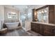 Luxurious bathroom with a freestanding tub, glass-enclosed shower, and custom vanity at 11007 Lake Katherine Cir, Clermont, FL 34711