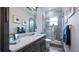 Bathroom with marble countertop, dark wood vanity, and seamless glass shower at 11007 Lake Katherine Cir, Clermont, FL 34711
